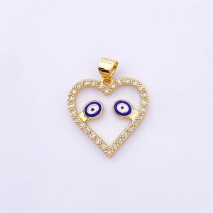 Macro detail of a golden heart-shaped evil eye pendant charm with sparkling zircons