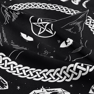 Close-up of black tapestry with white mystic cat print featuring crescent moon and stars