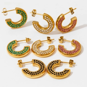Detailed view of C-shaped gold-plated stainless steel earrings with colorful rhinestones