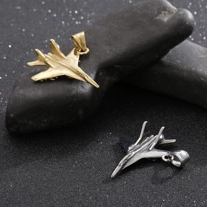 Detailed shot of titanium steel fighter jet pendants in gold and silver finish