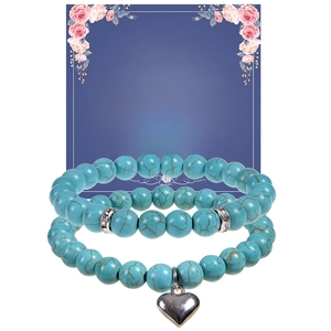Detail of turquoise bead bracelets with heart pendant on a motivational gift card