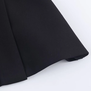 Detailed macro view of black twill fabric texture and fiber density on a fashion top