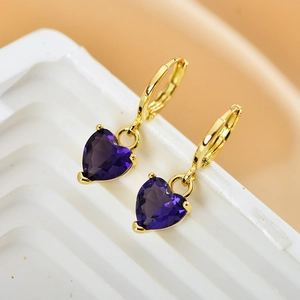 Close-up of gold hoop earrings featuring heart-shaped deep purple zircon pendants
