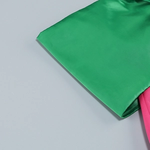 Detail of green satin and pink plain weave fabric on a fitted evening fishtail dress