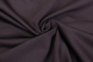 Macro view of plum purple ribbed fabric detail showing high-quality texture and draping