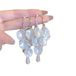 Elegant gold drop earrings with crystal petals and pearl fringe for a chic look