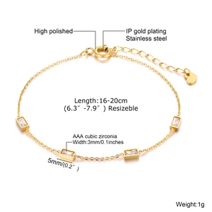 Macro detail of gold stainless steel bracelet with green AAA cubic zirconia and specs