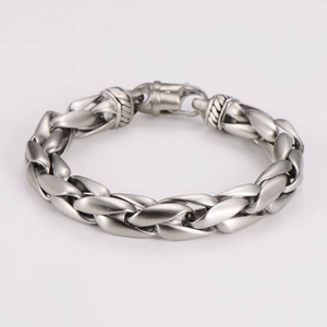 Detailed macro view of vintage woven stainless steel bracelet with industrial buckle clasp
