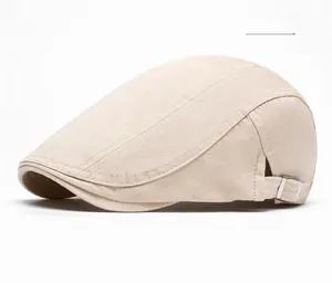 Close-up of the beige cotton newsboy cap with adjustable silver side buckle detail