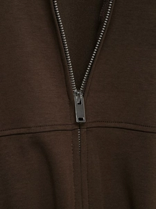 Close-up of metallic zipper and premium knit texture on dark brown track jacket