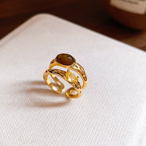 Detailed macro view of gold plated tiger eye ring and yellow zircon jewelry set