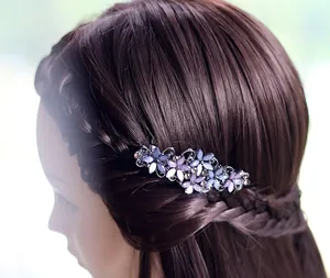 Detailed view of purple floral hair clip with rhinestones on braided hair style