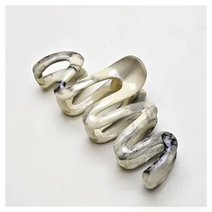 Detailed close-up of marble pattern hair claw clip with glossy water transfer finish