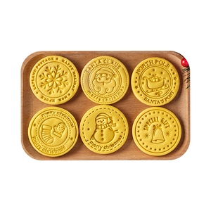 Set of 6 Christmas cookie molds with festive embossed patterns on a wooden tray