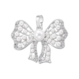 Close-up of bow pendant featuring silver metal with white pearls and sparkling crystals