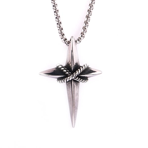 Detail of silver-tone cross pendant with twisted rope pattern and steel box chain