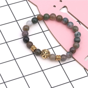 Macro shot of Indian agate beaded lion head bracelet with polished golden alloy beads