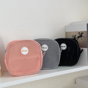 Detail view of mesh storage bags in pink, grey and black with BEAR logo and zipper