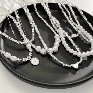 Elegant silver-toned irregular bead and pearl necklace set with heart and coin pendants