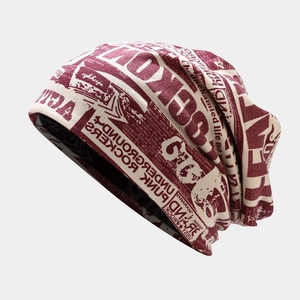 Retro newspaper print beanie in burgundy and cream featuring punk rock street style design