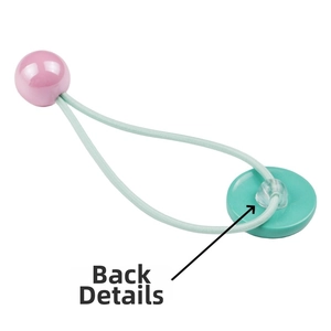 Macro shot showing the back attachment details of a colorful smiley face elastic hair tie
