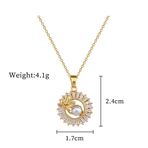 Detail view of gold leaf pendant with white pearl and zircon including size measurements