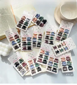 Macro detail of matte Morandi mini hair clips on decorative brand backing card