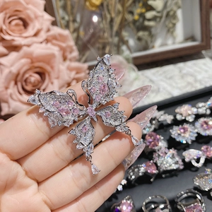Macro view of silver butterfly jewelry piece with sparkling pink and clear gemstones