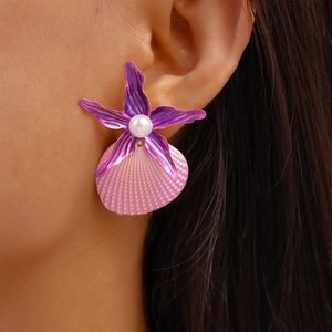 Detail of starfish and seashell drop earring with white pearl on model's ear