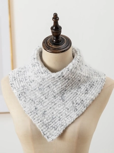 Detail of grey and white knitted turtleneck warmer showing thick triangular crochet texture