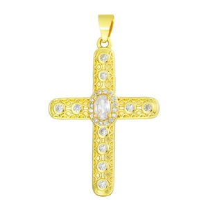 Macro view of a gold cross pendant with cubic zirconia inlay and intricate engravings