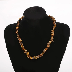Detail of natural tiger eye crystal stone beads on a multi-layered beaded necklace