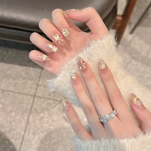 Christmas fireworks press-on nails with snowflake, tree, and glitter on nude base