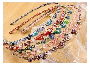 Detailed close-up of colorful braided crystal headbands with vibrant beads and gold threads