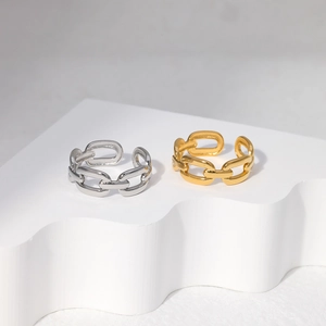 Detail of gold and silver chain link style open rings on a wave shaped display