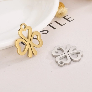 Detailed view of hollow clover charms in gold and silver finish for DIY jewelry