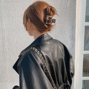 Large acetate leopard print geometric hair claw clip styled on woman's red-brown hair bun