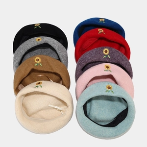 Top view of sunflower embroidered wool berets in nine various vibrant colors