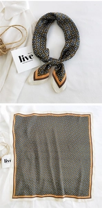 Detail showing elegant geometric floral silk scarf styled as a knot on a white shirt