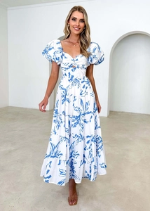 Detailed view of the blue and white floral dress featuring a knot cutout and layered skirt