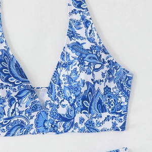 Detail of blue and white paisley bikini top with halter neck and deep V-neckline