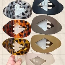 Close-up of heart-shaped dopamine hair clips in leopard print and solid colors