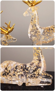 Detailed macro view of the clear resin elk figurine with embedded gold foil flakes