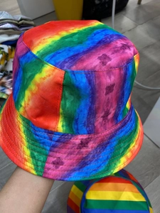 Detail of colorful rainbow striped reversible bucket hat fabric texture and stitching