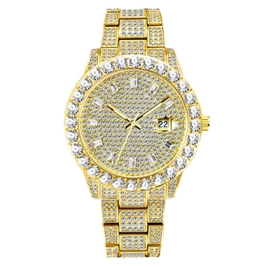 Macro shot of gold hip hop watch with iced-out crystals and date window at 22