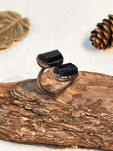 Detail of vintage bronze adjustable ring with two natural raw black tourmaline stones