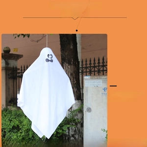 Close-up of white Halloween ghost hanging decoration with a funny face expression