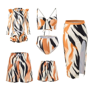 Matching family swimwear set with vibrant orange and black tiger print patterns