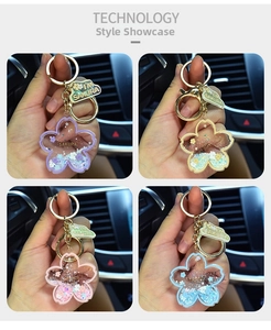 Detail view of four colorful sakura liquid keychains with glitter and floral charms