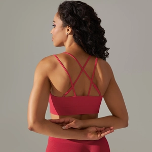 Detail of cross-back straps and ribbed texture on dark pink seamless sports bra